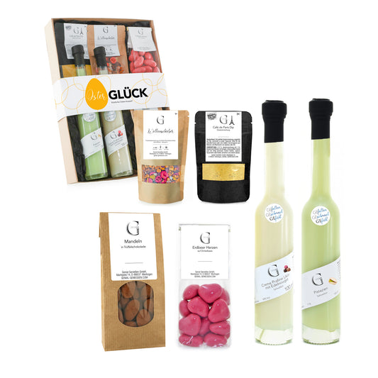 Liebevoll zusammengestelltes Osterglück Geschenkset von Genial Genießen mit Pistazien-Sahnelikör, Pralinenlikör, Trüffelschokoladen-Mandeln, Tee und feinen Genussprodukten in dekorativer Geschenkverpackung.
