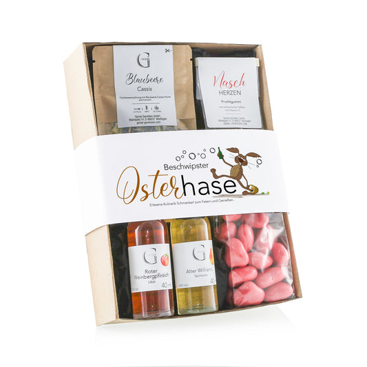 Genial Genießen Beschwipster Osterhase Geschenkset mit ausgewählten Feinkostspezialitäten, Likören, Süßigkeiten und Gewürzen in dekorativer Oster-Geschenkverpackung für genussvolle Feiertage.