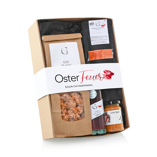 Genial Genießen Osterfeuer Geschenkset mit ausgewählten Feinkostprodukten, süßen und herzhaften Spezialitäten sowie edlen Getränken in dekorativer Verpackung für genussvolle Ostermomente.