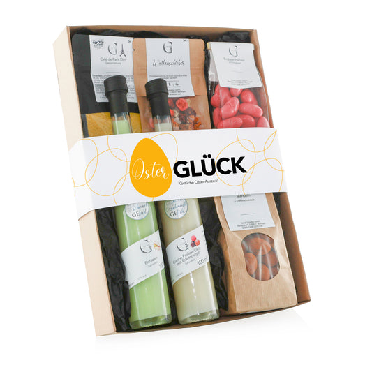 Genial Genießen Osterglück Geschenkset mit ausgewählten Delikatessen, feinen Likören, Schokoladenspezialitäten, Tee und Gewürzen, stilvoll verpackt als hochwertiges Ostergeschenk für Genießer.